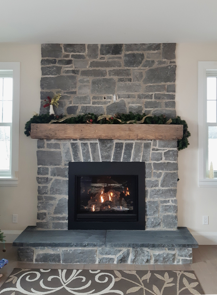 fireplace with wood beam